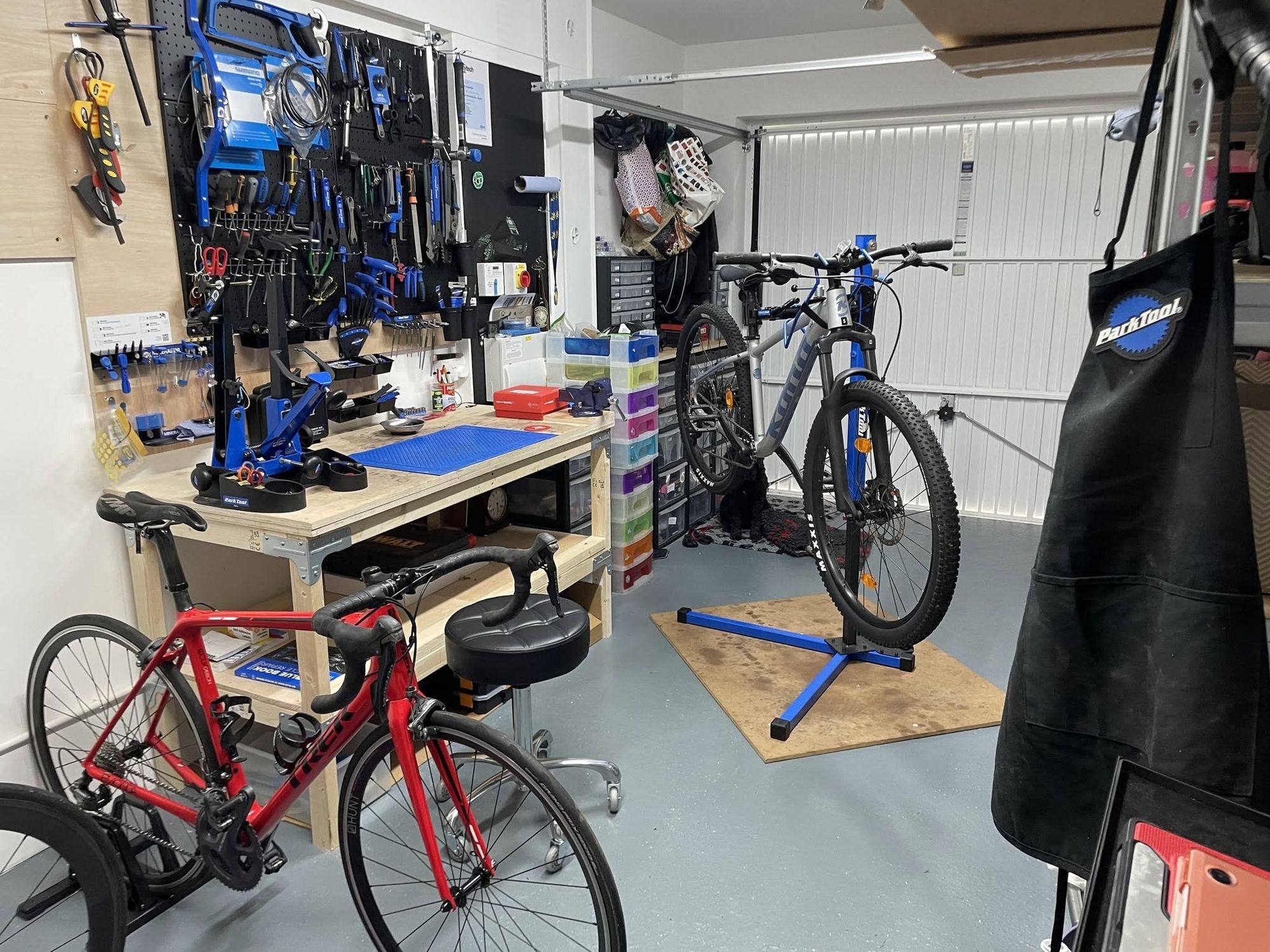David Stephen Cycles home workshop in Dundee, with bikes on repair stands and a wall of tools
